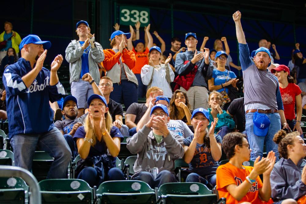 Group photo of people cheering in the stands of Comerica Park